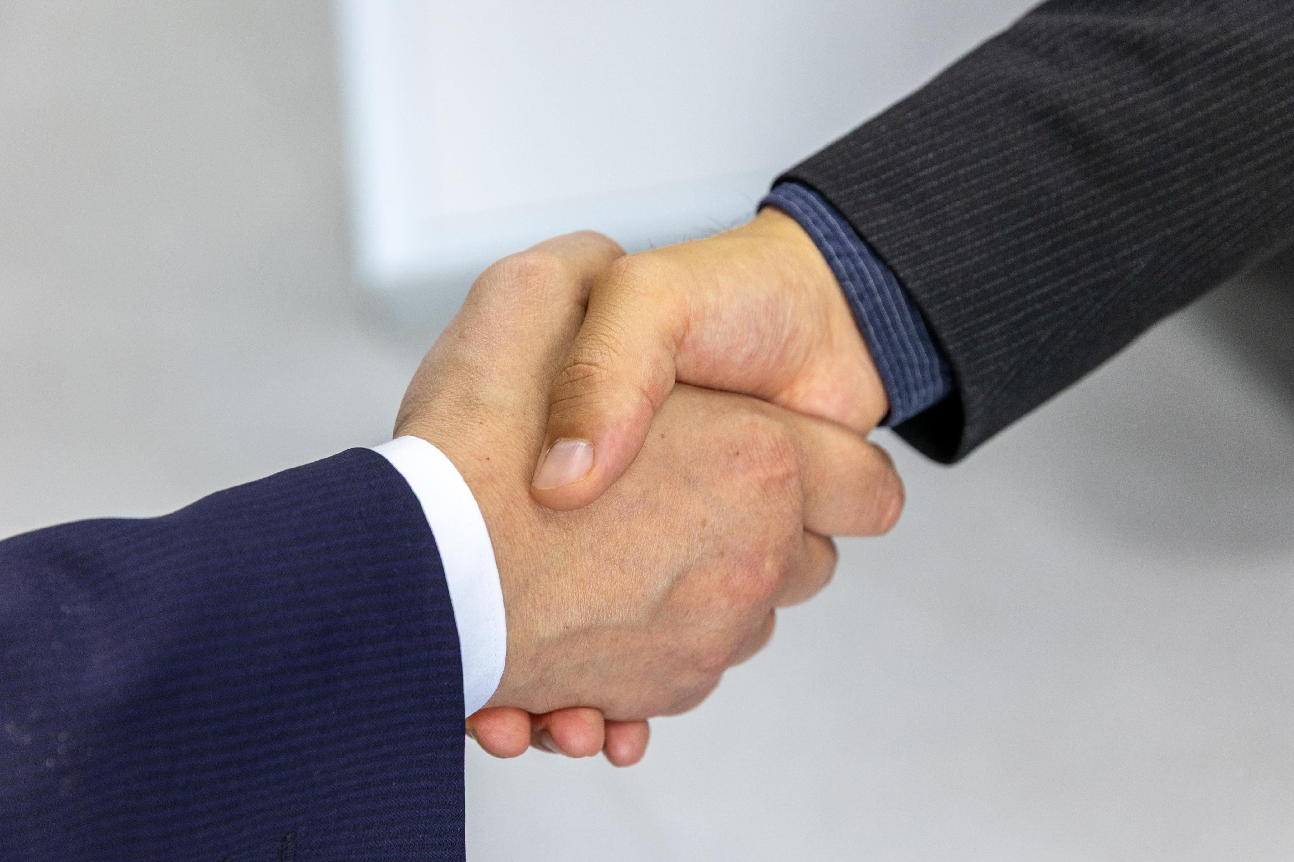 Two businessmen shaking hands after reaching a contract agreement