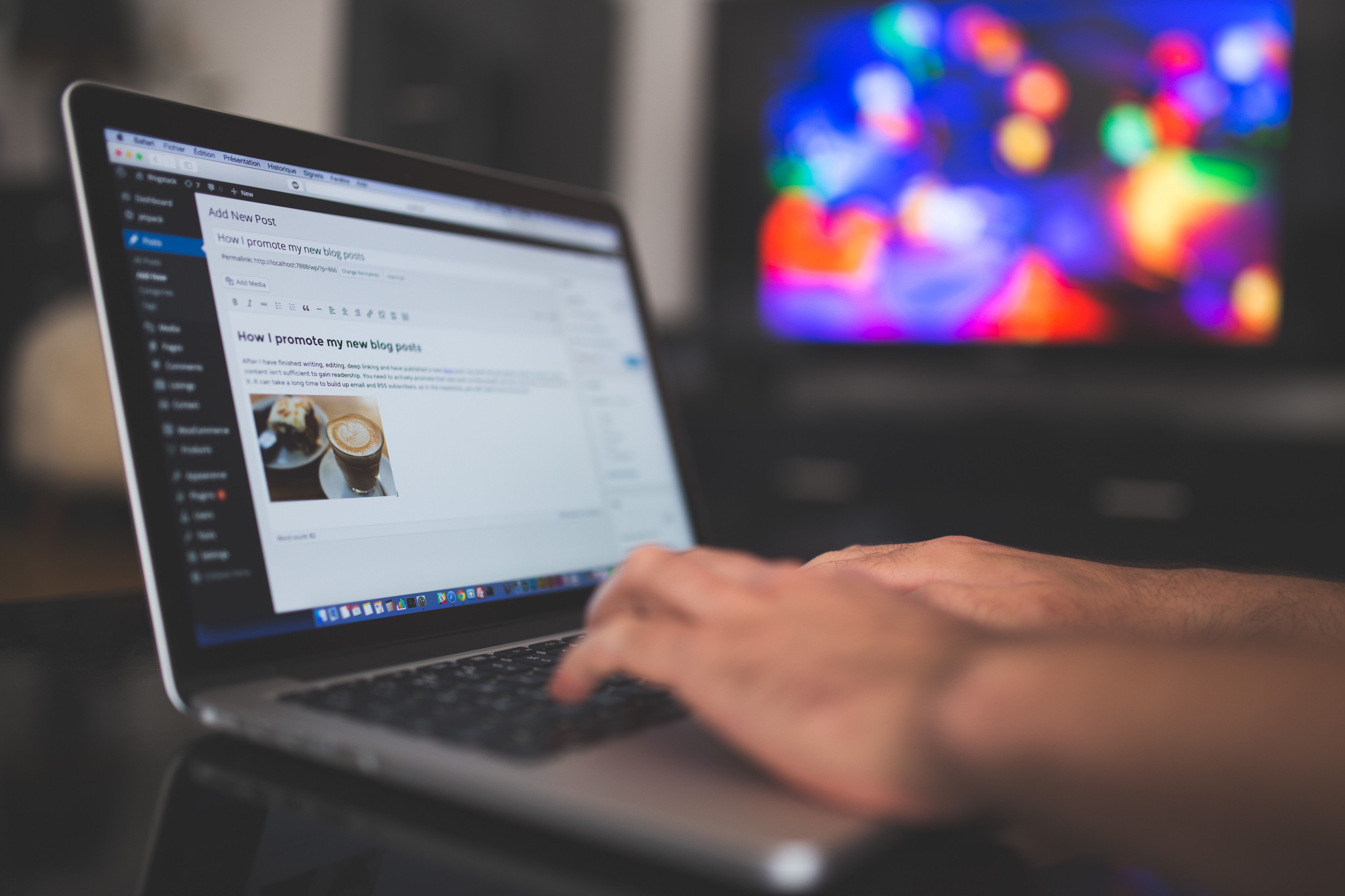 Hands typing a blog post on a laptop, representing quality content for SEO