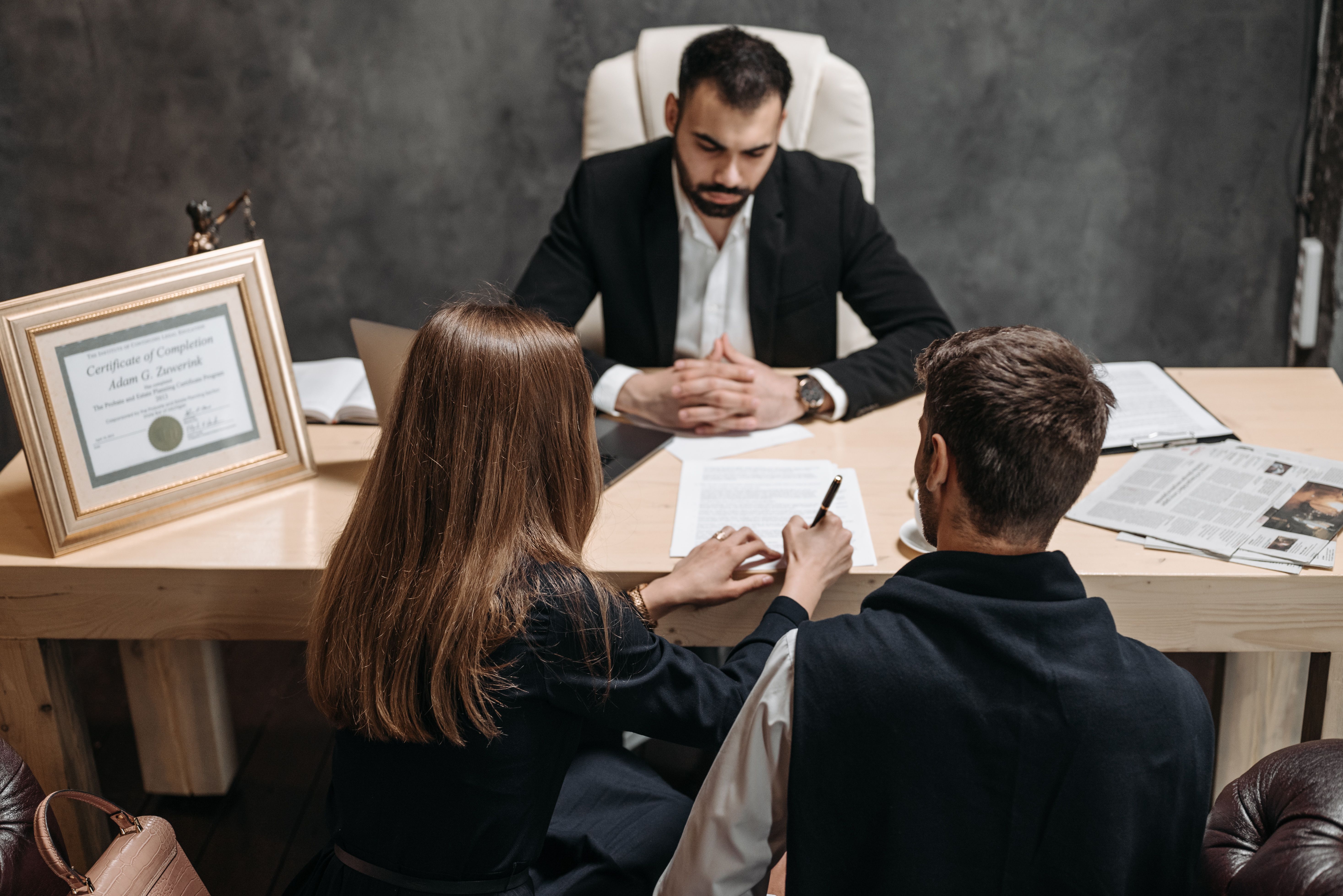 Lawyer discussing legal contract terms with clients before signing