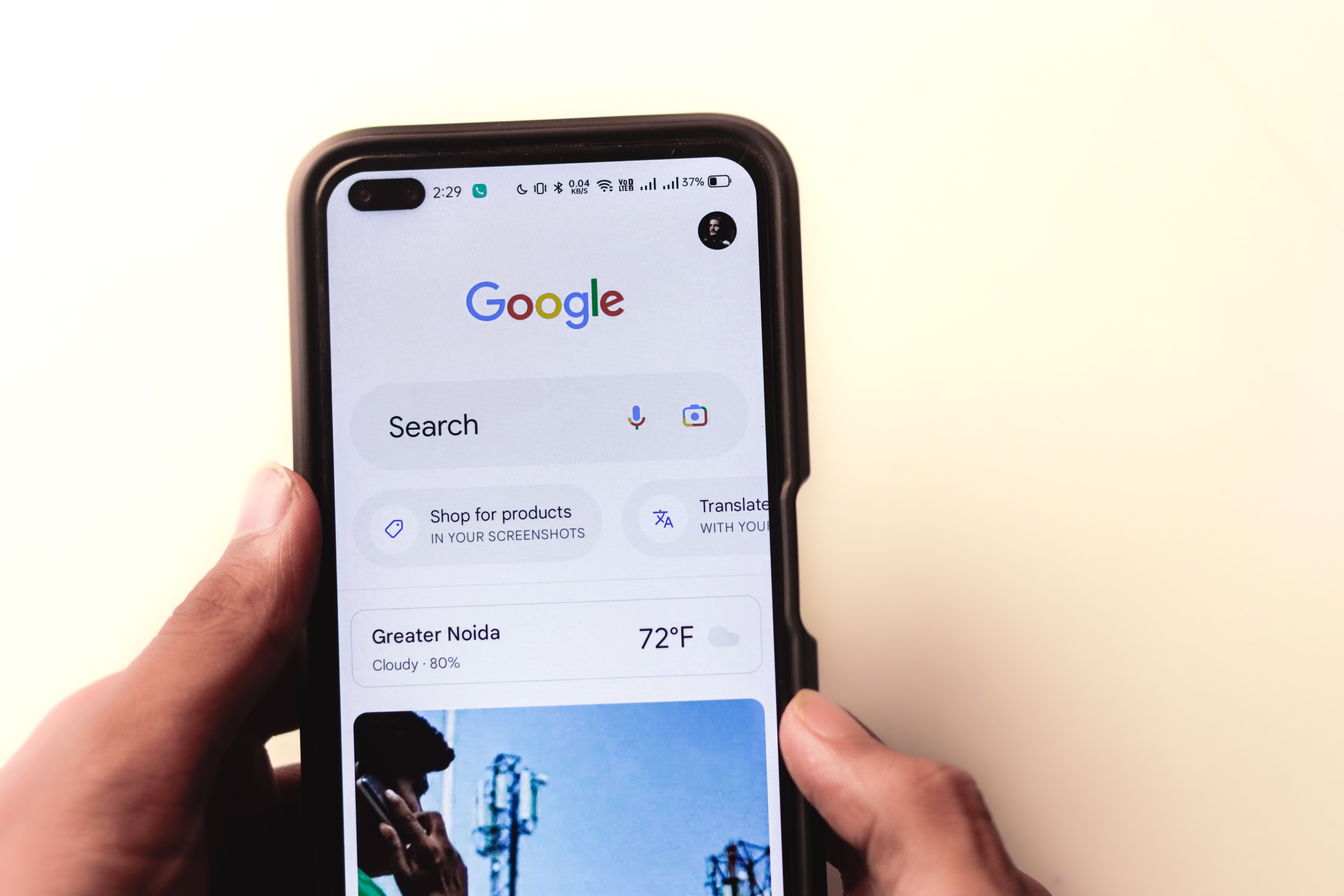 Hand holding a smartphone displaying Google search results for mobile SEO
